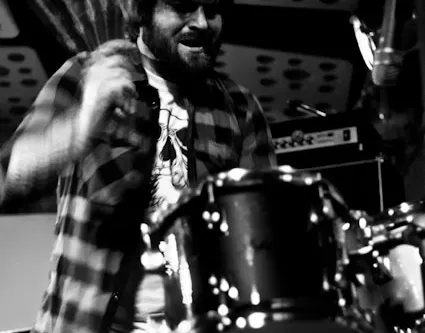 Chris Garth performing behind a drum kit